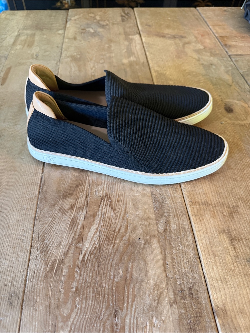 UGG Women's Black Slip-On Knit Flats with Tan Heel Accent